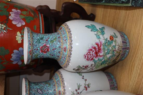 A pair of Chinese famille rose vases and another similar (3) Height 36cm